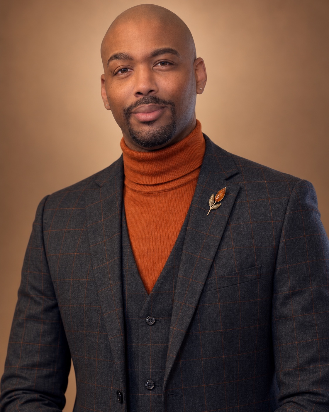 Brennden D. Colbert in a rust turtleneck and dark jacket